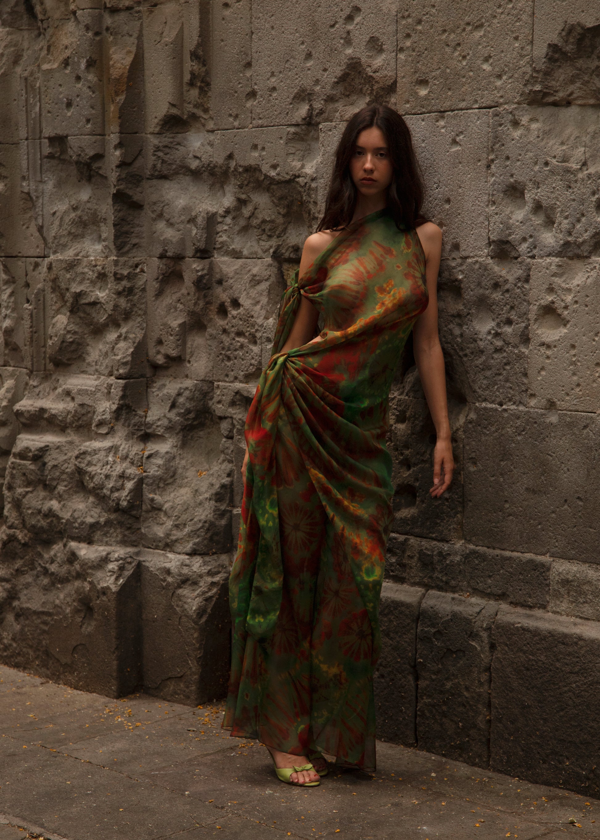 Woman in Dramatica Dress Nimphidia  standing against a stone wall