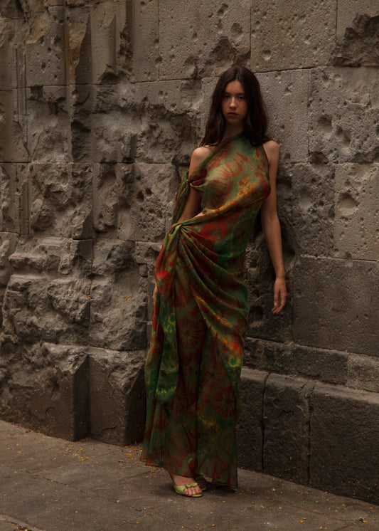 Woman in Dramatica Dress Nimphidia  standing against a stone wall