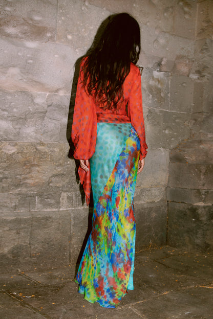 Woman wearing Exotica skirt in daydream against stone wall