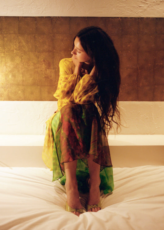 Woman wearing Exotica skirt in nimphidia on bed.